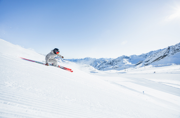 Skifahrerin auf perfekter Piste am Stubaier Gletscher mit dem Stubaital im Hintergrund